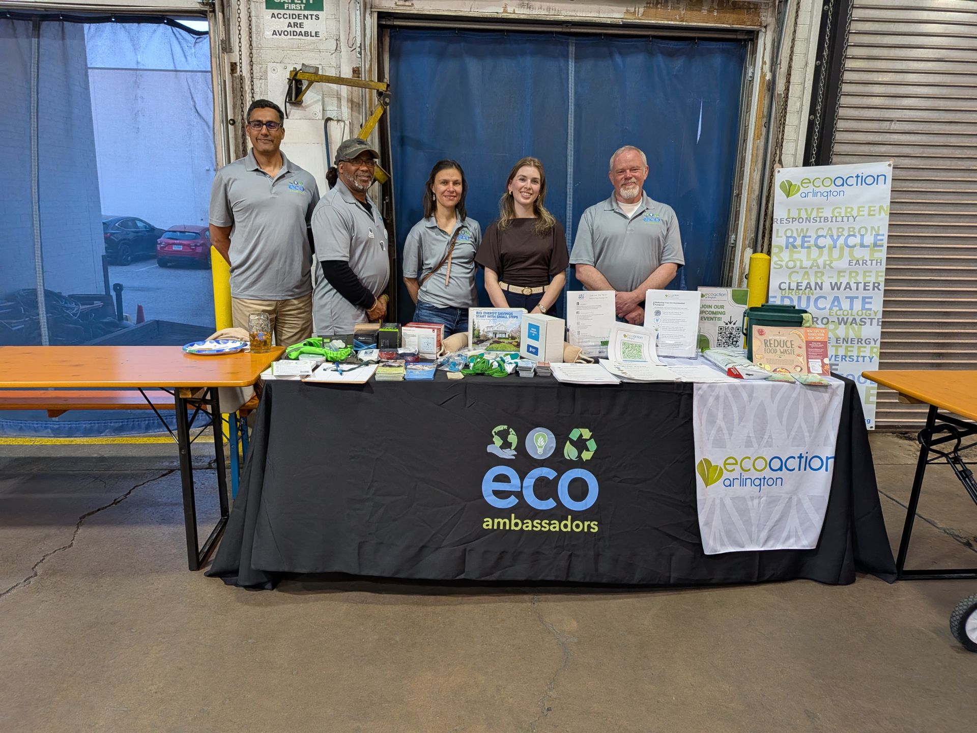 EcoAmbassadors standing behind table with information on energy savings